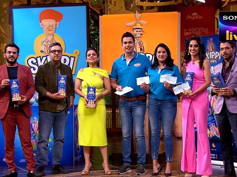 Entrepreneurs and investors from Shark Tank India holding products and smiling, celebrating a successful pitch on the show