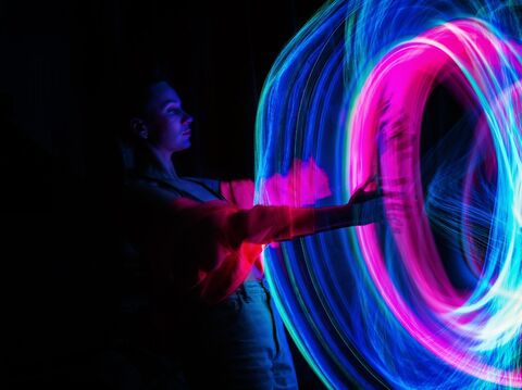 A man with a motion blur of purple and blue in circular shape