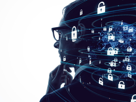 Silhouette of a person with digital security graphics overlay, representing cybersecurity concepts