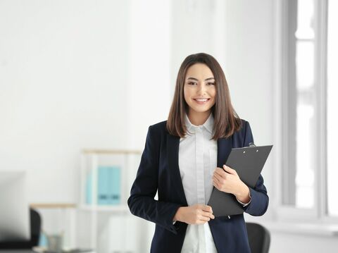 A executive woman holding a board ready for a presentation in formals