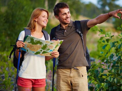 A man and a woman navigating using a paper map