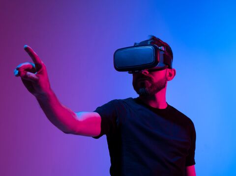 A man wearing a virtual reality (VR) headset, actively engaged with a virtual environment