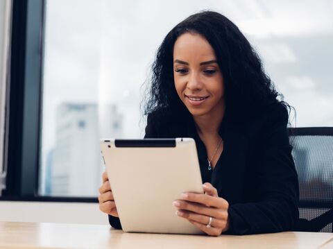 A woman on her tablet using ChatGPT