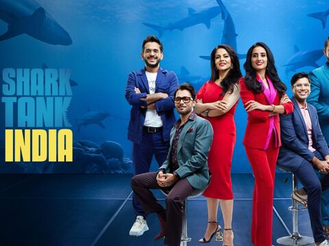 The panel of Shark Tank India investors posing confidently with the show's logo in the background, set against an underwater theme