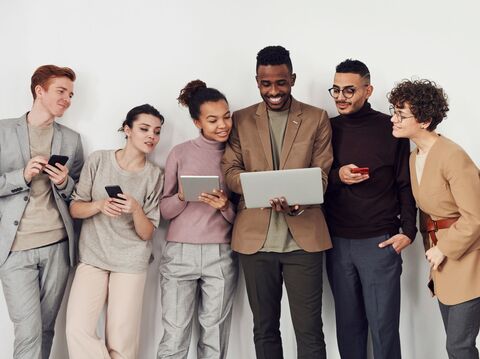 Diverse team discussing content on a laptop