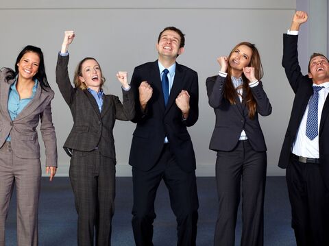 5 executives jumping in air in joy