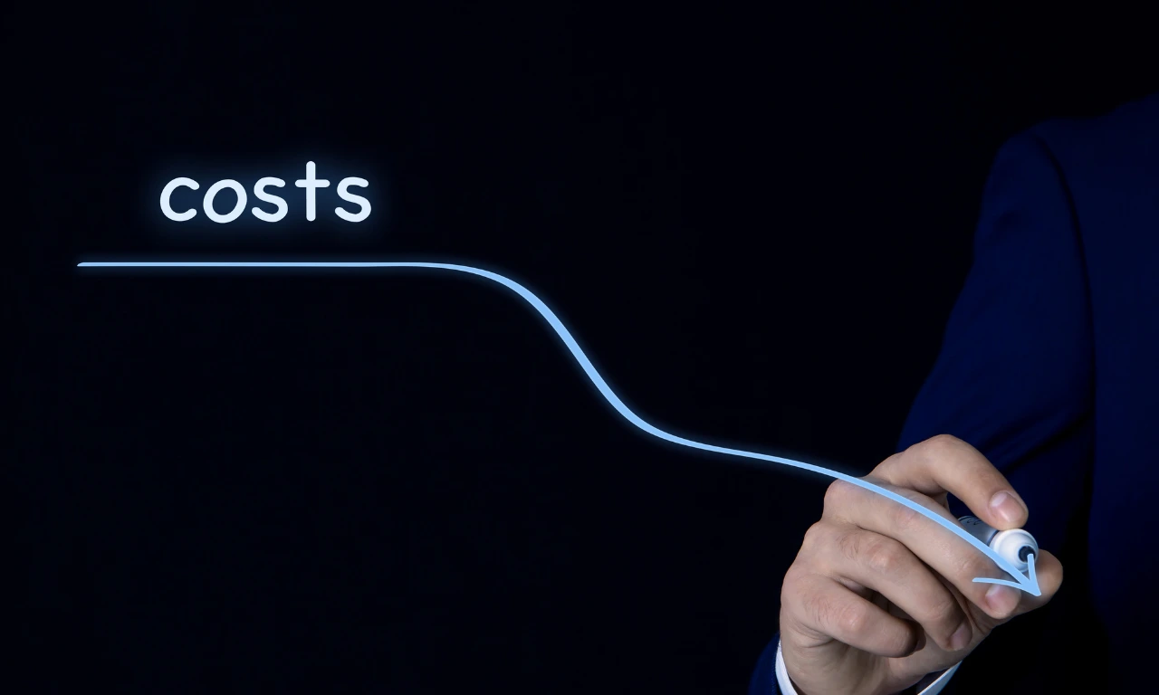 A person drawing a downward line to represent reducing costs, symbolising affordable healthcare innovation and low-cost medical device development in India.