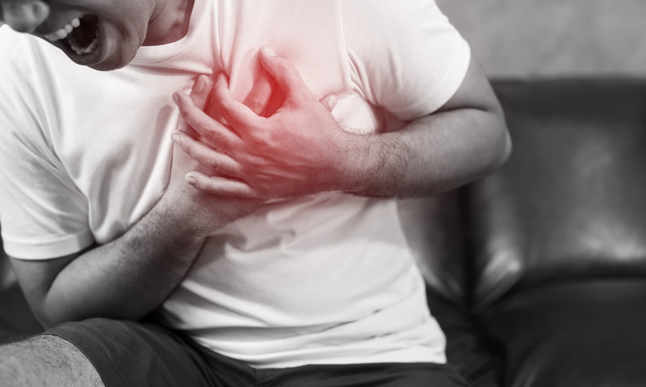Man clutching chest in pain, illustrating symptoms of chronic disease and the need for predictive healthcare engagement.