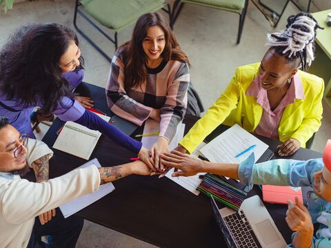 Diverse group of students studying together outdoors