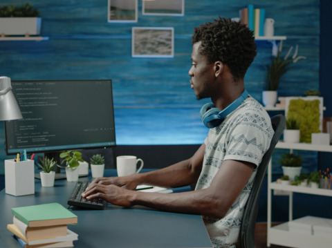 People working collaboratively with laptops on a table