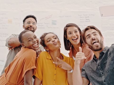 A group of five taking a selfie, three women and two men